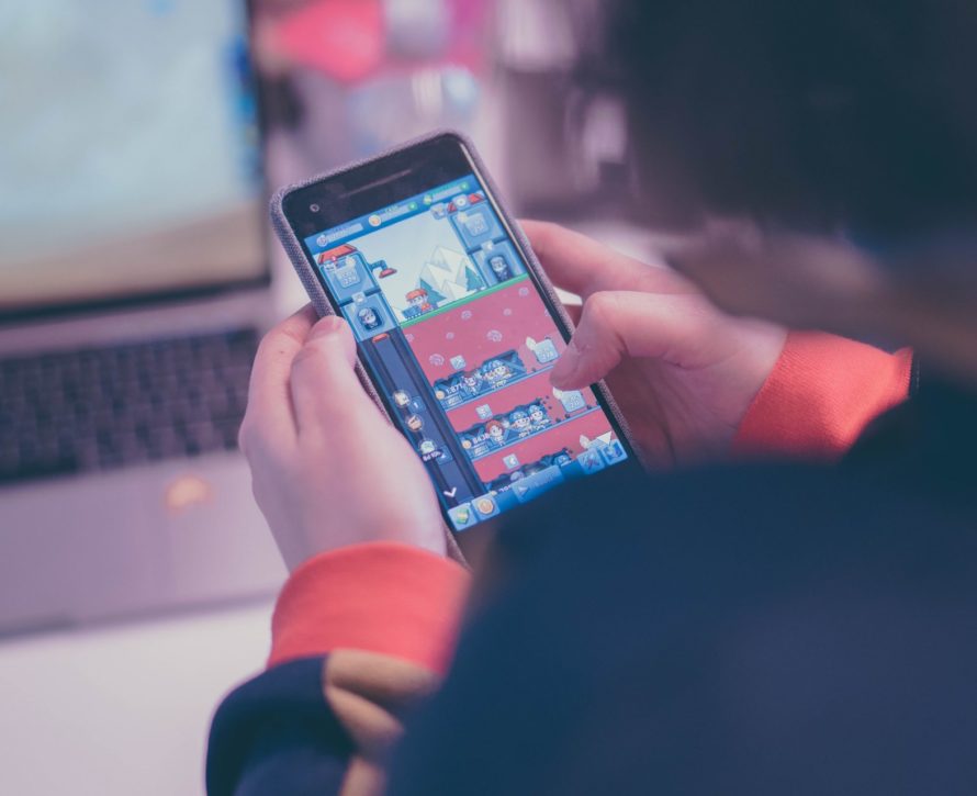 Person playing Idle Miner Tycoon on mobile device